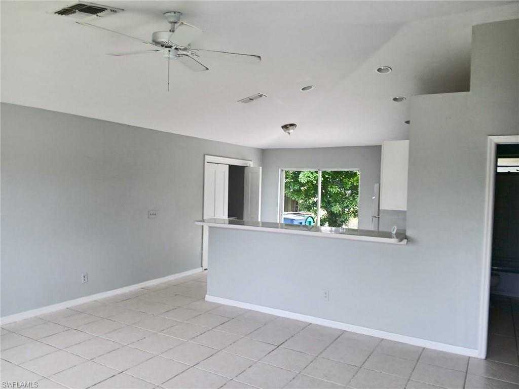 Unfurnished room featuring light tile patterned flooring, ceiling fan, and recessed lighting