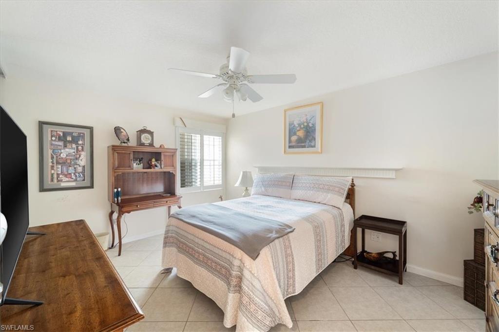 Bedroom featuring light tile patterned floors and a ceiling fan