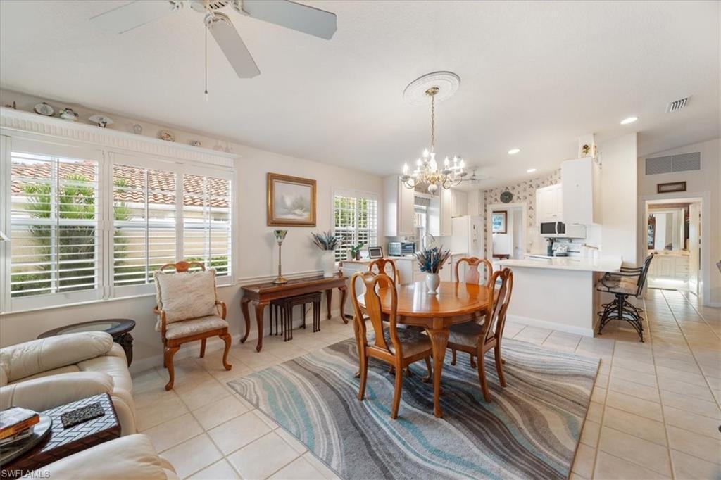 Dining room featuring recessed lighting, a chandelier, light tile patterned floors, and a ceiling fan