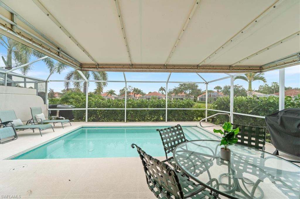Swimming pool featuring a lanai, a sunroom, and area for grilling