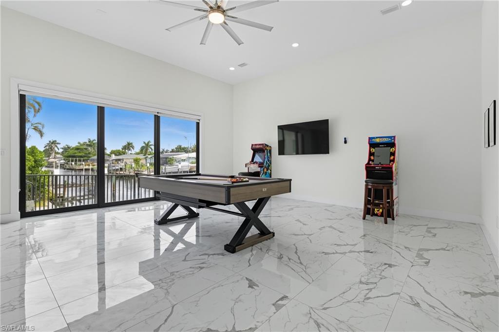 Game room featuring light marble finish floors, recessed lighting, ceiling fan, and pool table