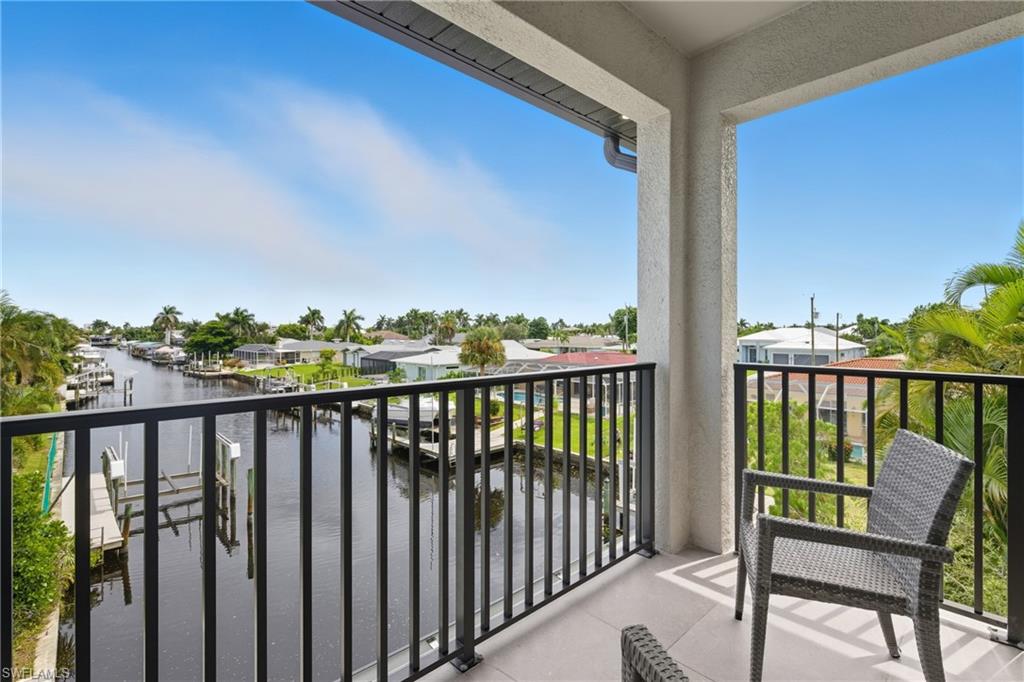 Balcony featuring a water view and a residential view