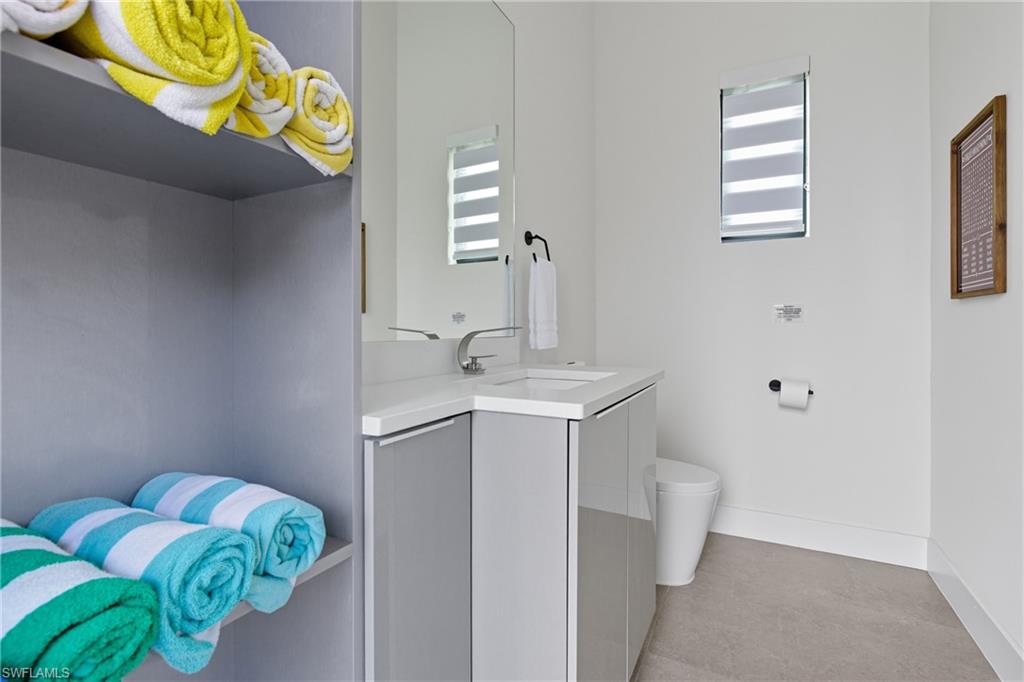 Bathroom with vanity and baseboards
