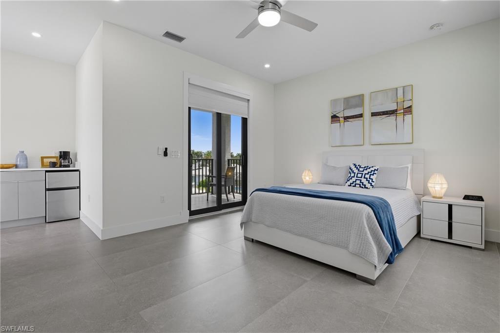 Bedroom featuring freestanding refrigerator, recessed lighting, access to outside, and a ceiling fan