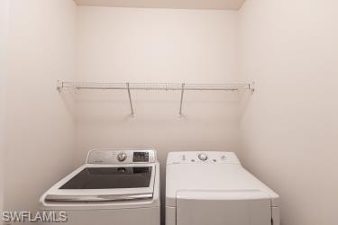 Laundry room featuring washer and clothes dryer