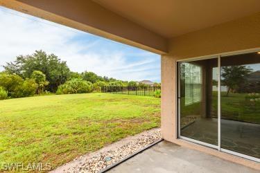 View of green lawn with a patio area