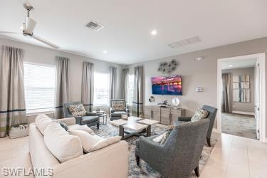 Living room featuring tile patterned floors and recessed lighting