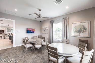 Dining room with recessed lighting and a ceiling fan