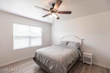 Bedroom featuring wood finished floors and a ceiling fan