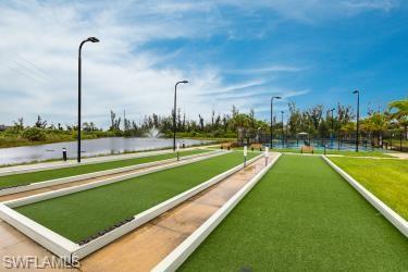 View of property's community with a game area and a water view