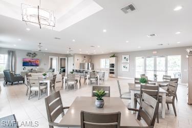 Dining space with a chandelier, light tile patterned floors, and recessed lighting