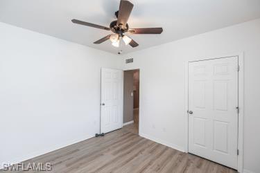 Unfurnished bedroom with light wood finished floors and ceiling fan