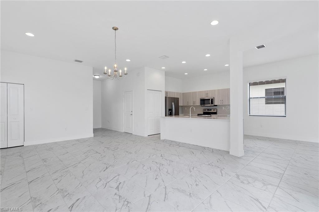 Different angle of living room featuring tile  flooring, and recessed lighting.