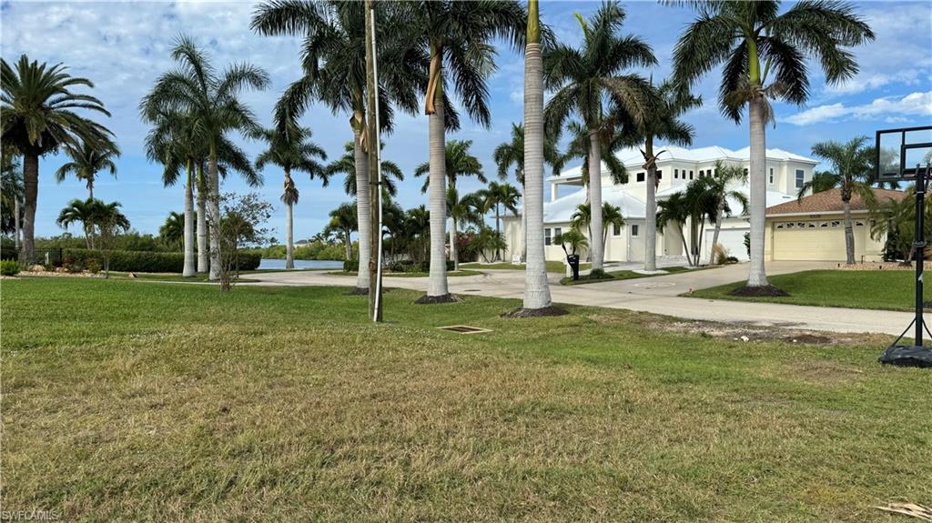 Surrounding community with a yard and a water view