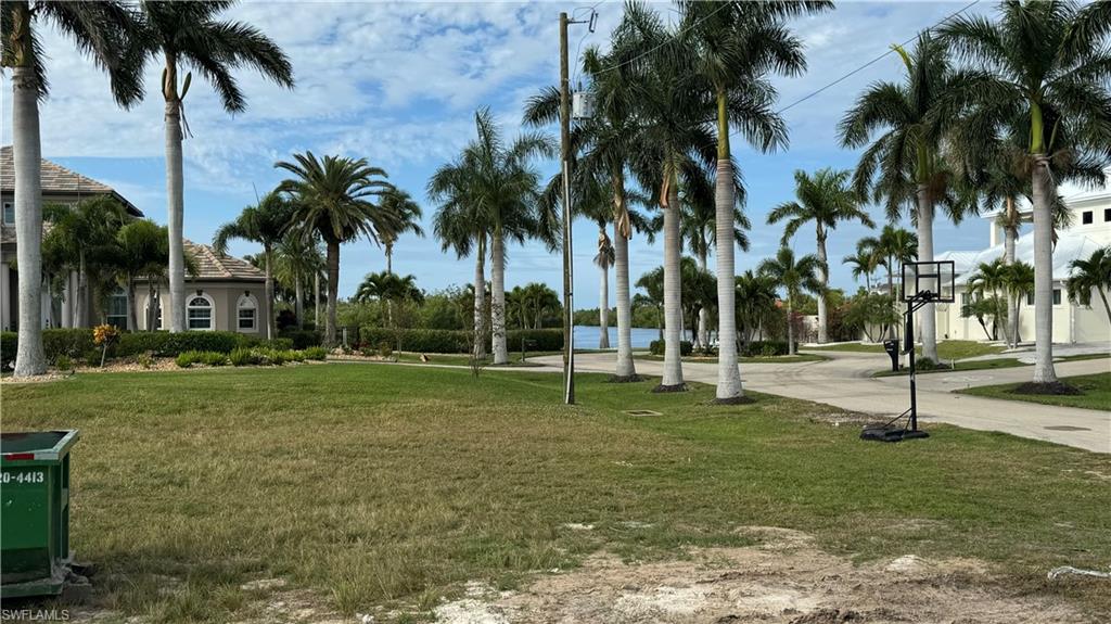 View of community featuring a water view and a lawn