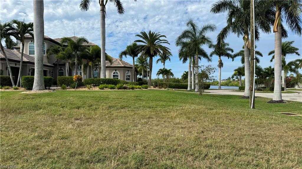 View of grassy yard with a water view