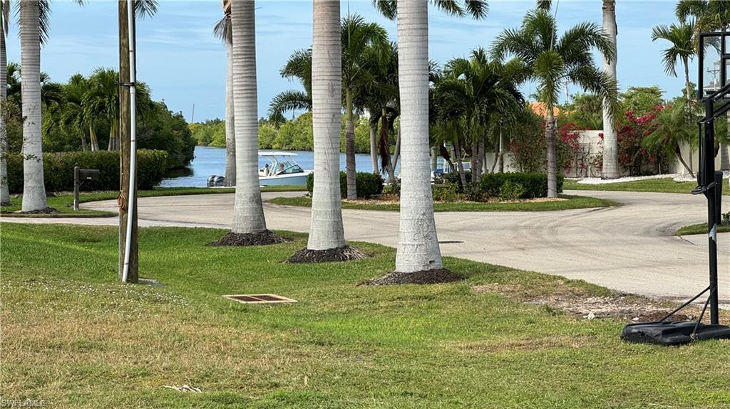 View of community with a lawn and a water view