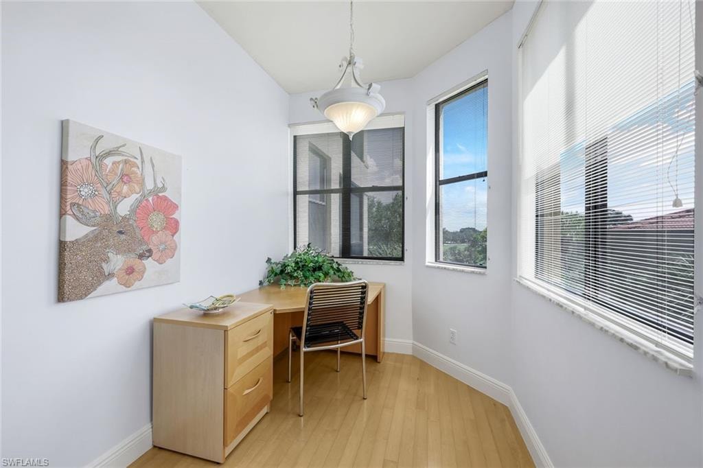 Office area with baseboards and light wood finished floors