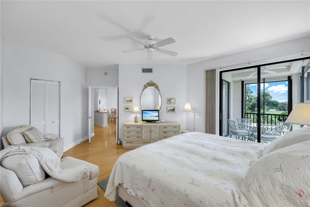 Bedroom with light wood-style floors, access to outside, ceiling fan, and a closet
