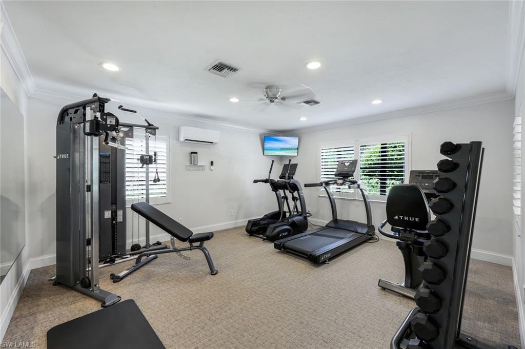 Exercise area featuring crown molding, carpet, recessed lighting, and a ceiling fan
