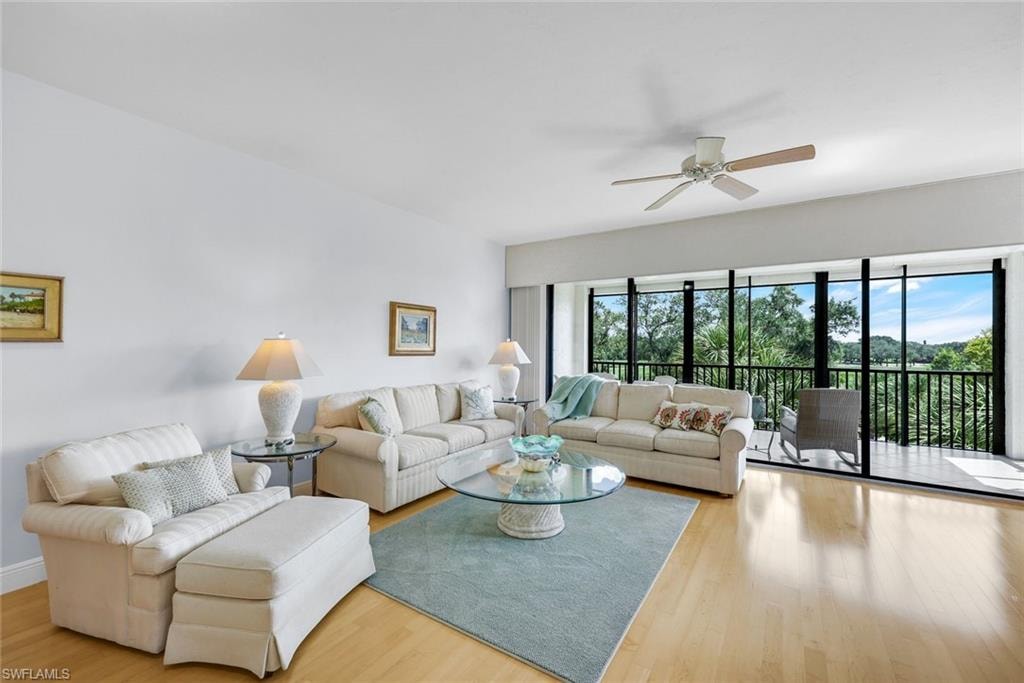Living room featuring wood finished floors and a ceiling fan