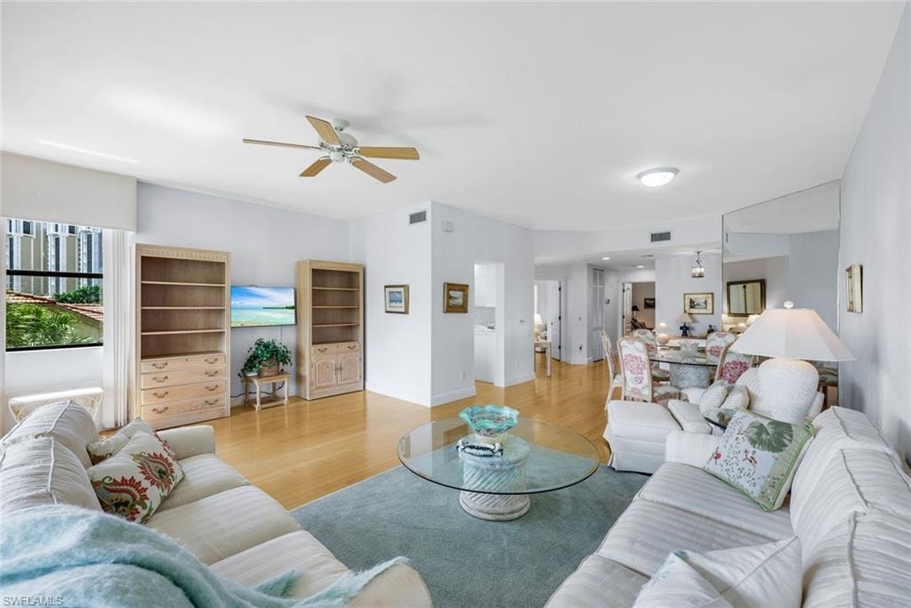 Living room featuring wood finished floors and a ceiling fan