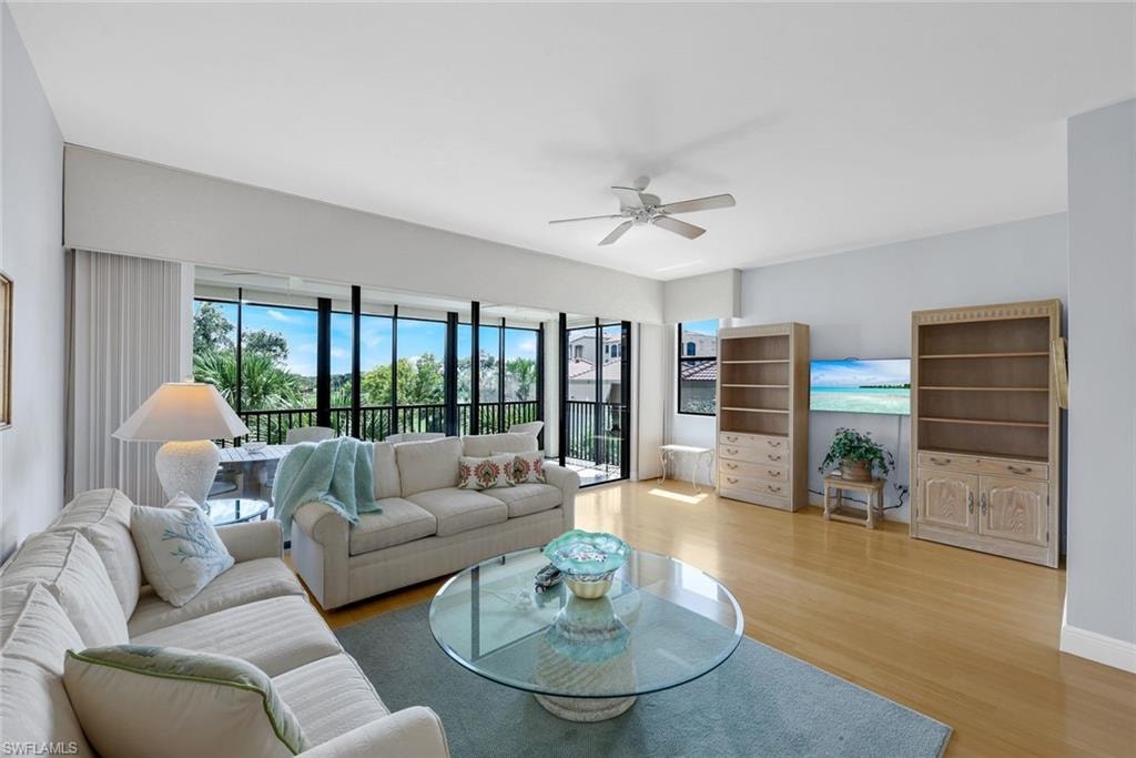 Living room with wood finished floors and ceiling fan