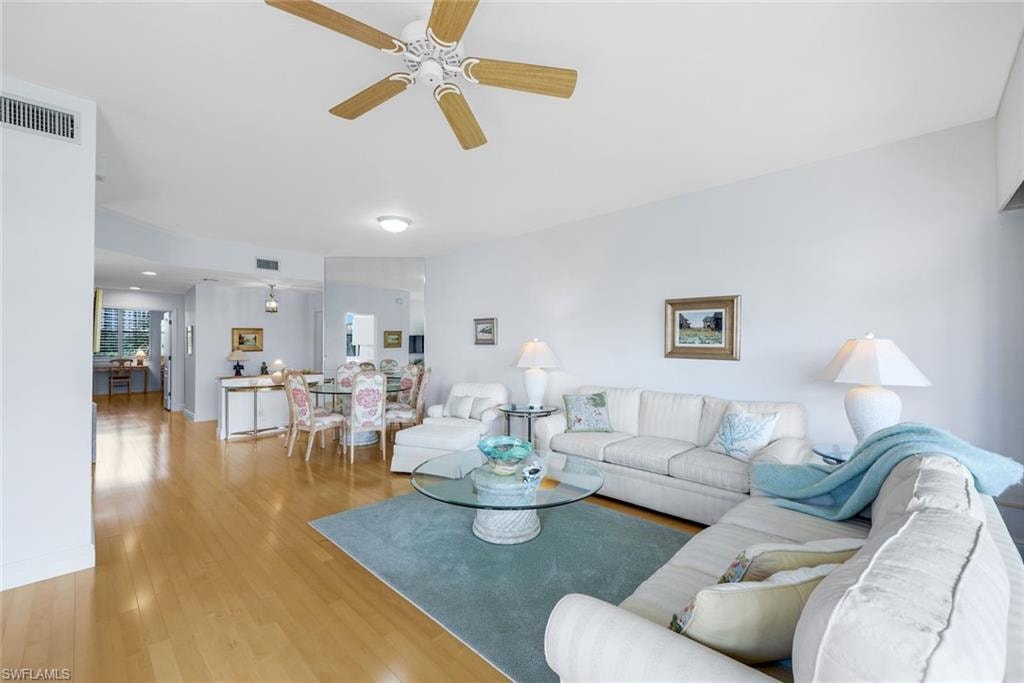 Living room featuring light wood-type flooring and a ceiling fan