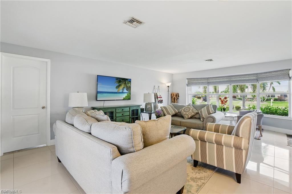 Living area featuring light tile patterned floors and baseboards