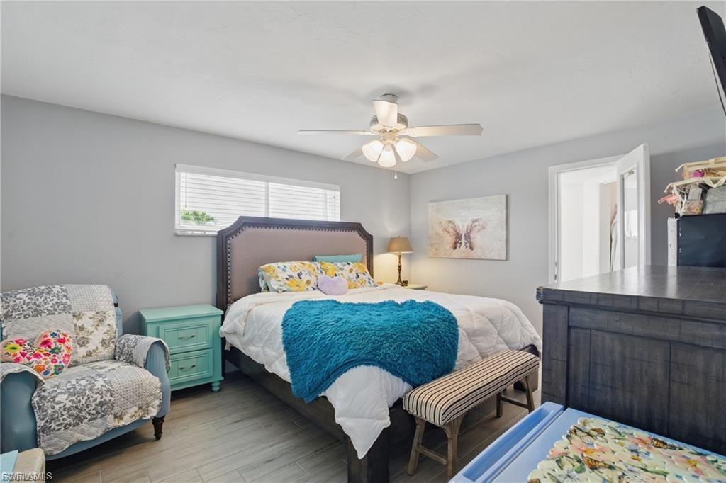 Bedroom with wood finished floors and ceiling fan