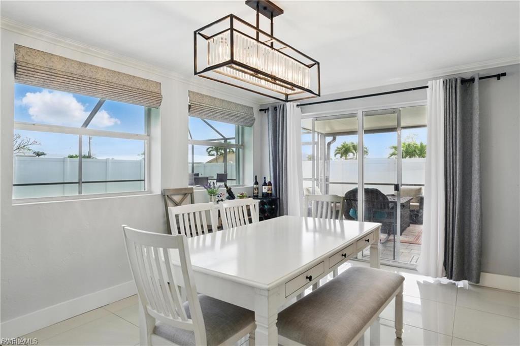 Dining space with light tile patterned floors and baseboards