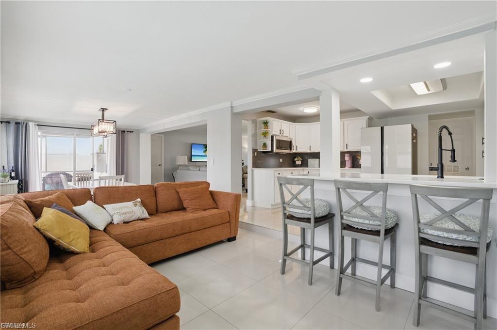 Living room featuring light tile patterned floors and recessed lighting