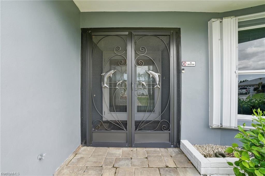 Doorway to property with stucco siding