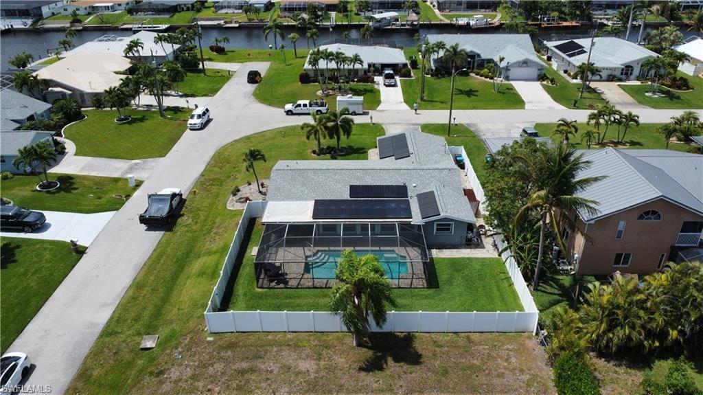 Aerial view of residential area with a large body of water and a pool area
