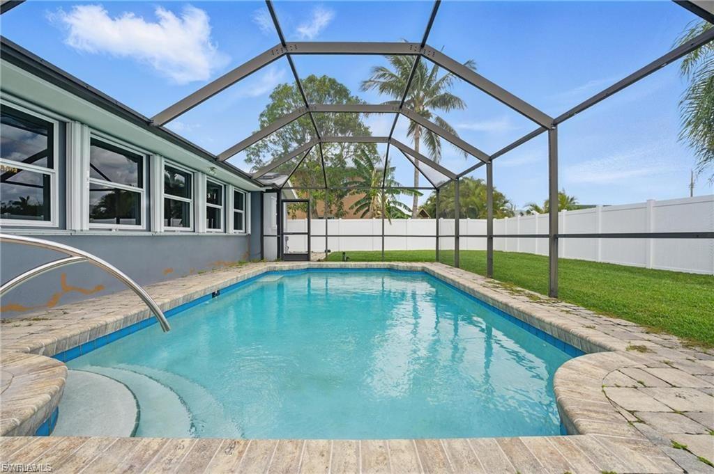 View of pool with a sunroom, a lanai, and a patio
