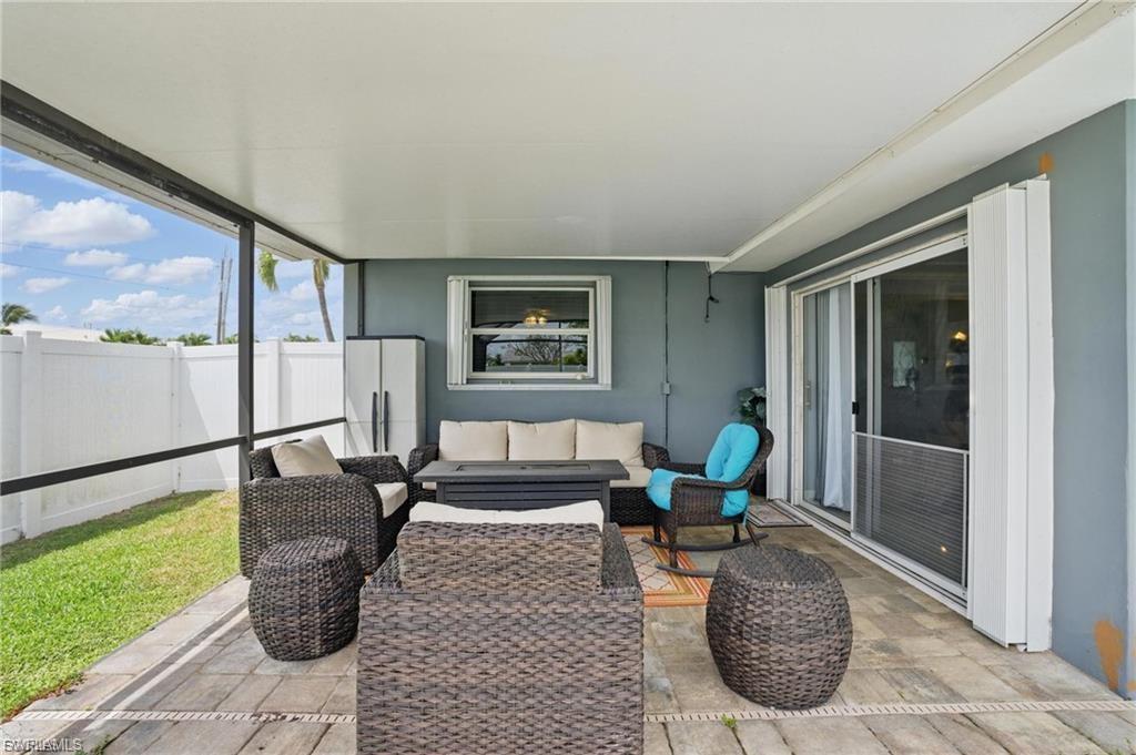 Sunroom featuring an outdoor living space and a patio
