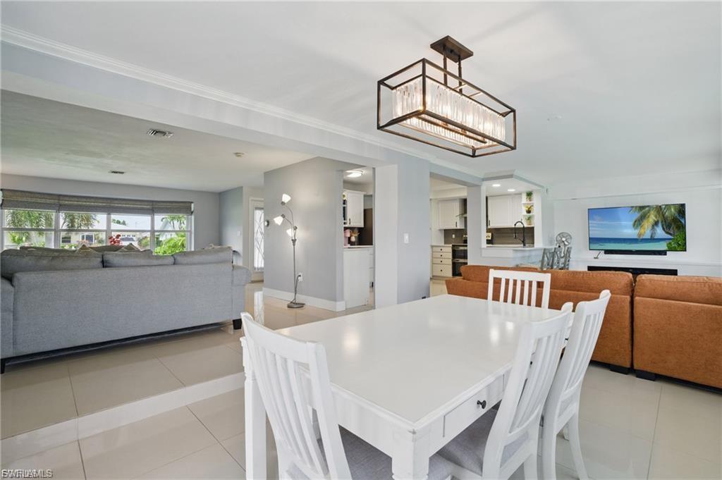 Dining room with light tile patterned flooring and baseboards