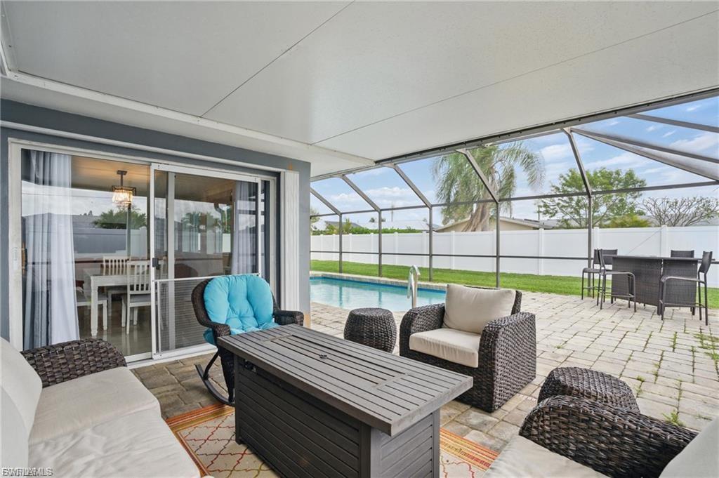 View of patio with a sunroom, glass enclosure, outdoor lounge area, and outdoor dining area