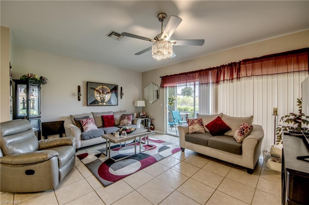 Living area with light tile patterned flooring and a ceiling fan