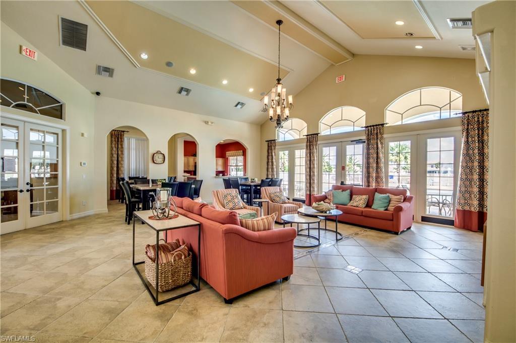 Clubhouse featuring french doors, high vaulted ceiling, beam ceiling, recessed lighting, and arched walkways