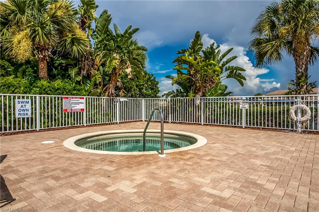 View of pool with a hot tub