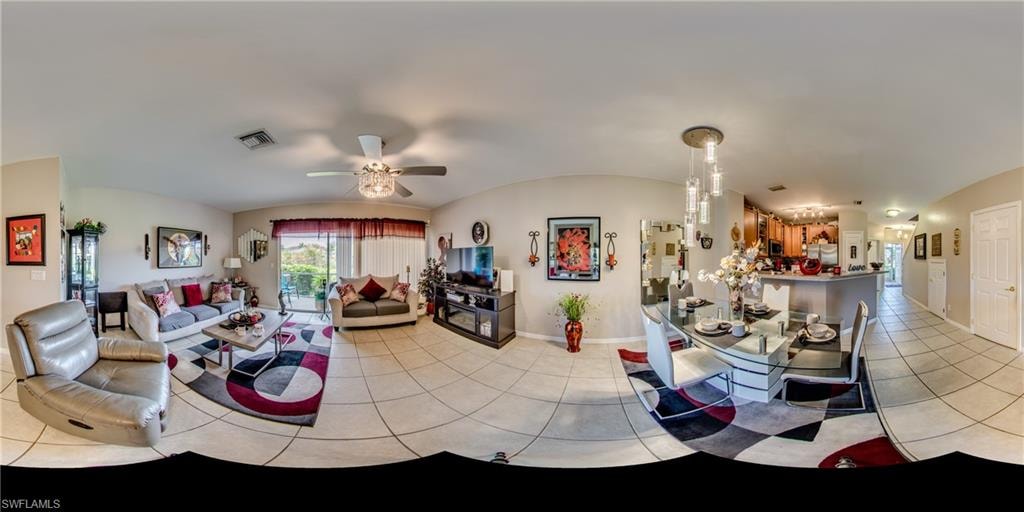 Living room featuring light tile patterned floors, lofted ceiling, and a ceiling fan