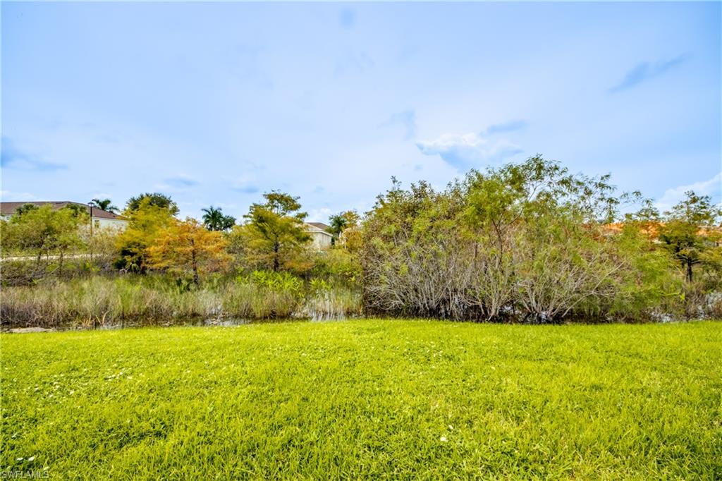 View of green lawn with a water view