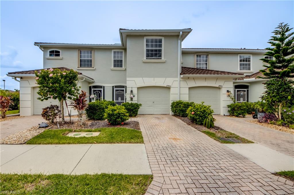 View of front facade featuring decorative driveway and stucco siding