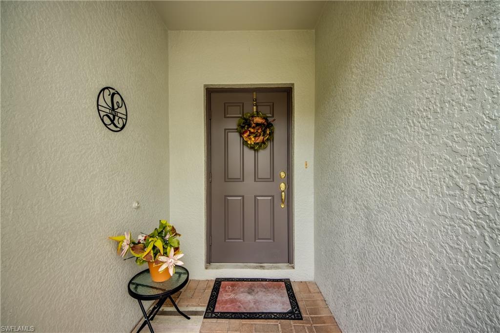 Doorway to property featuring stucco siding