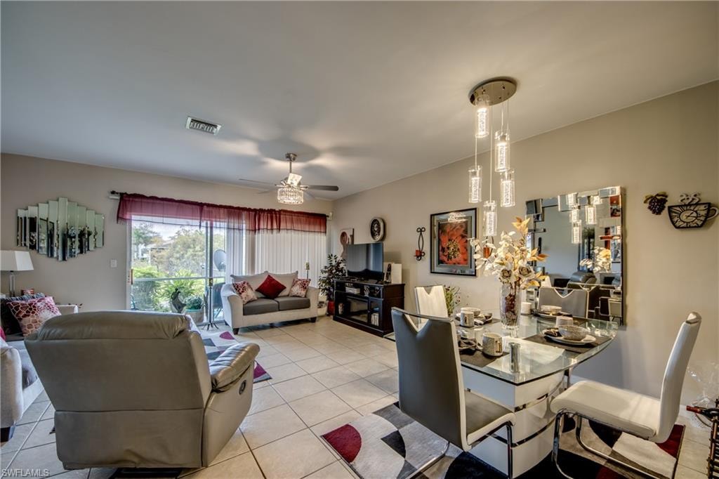 Dining space with tile patterned floors and a ceiling fan