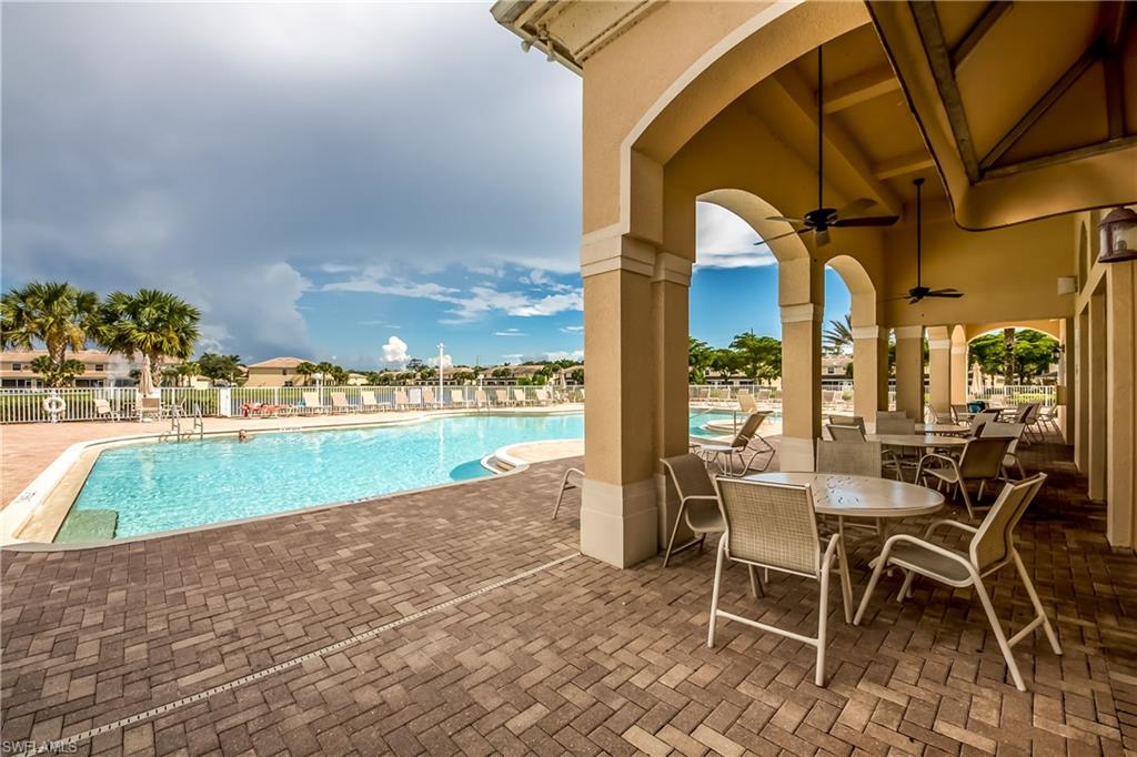 Community pool featuring a patio area and a ceiling fan