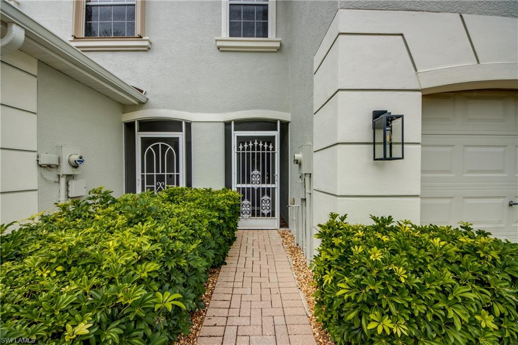 Doorway to property featuring stucco siding