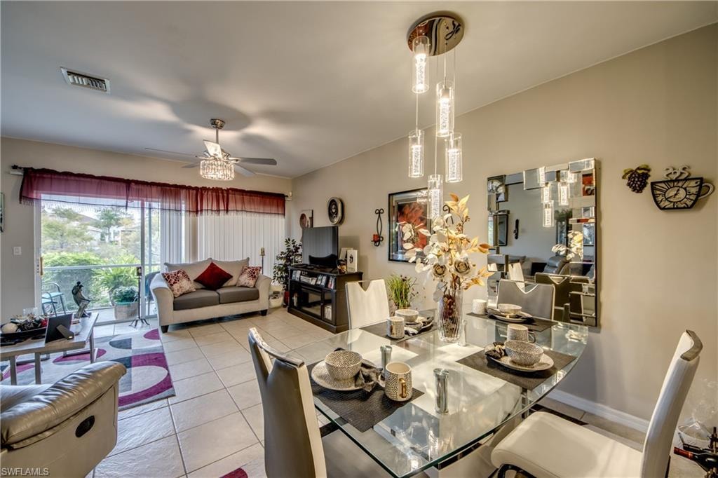 Dining space featuring light tile patterned floors and ceiling fan