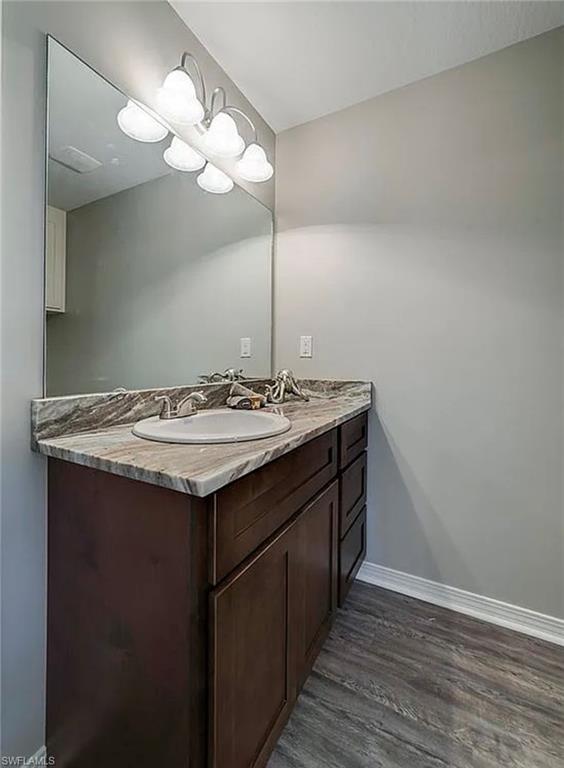 Bathroom with vanity and dark wood-type flooring